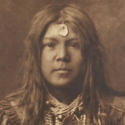 Photograph of young member of the Apache tribe.