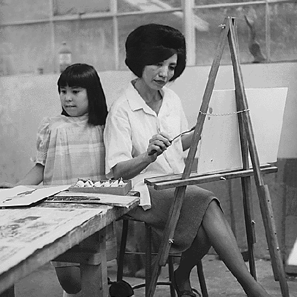 Woman and young girl painting.